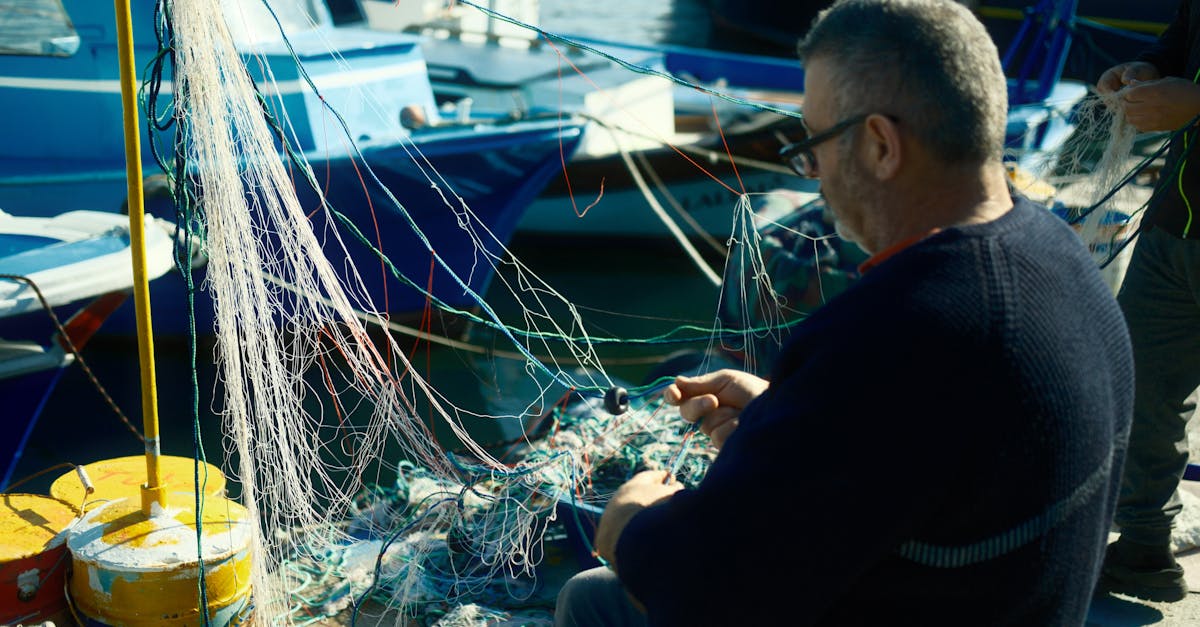 A man sitting on a boat with fishing nets