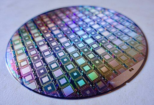 A zooming in on a wafer of D-Wave Quantum Computers