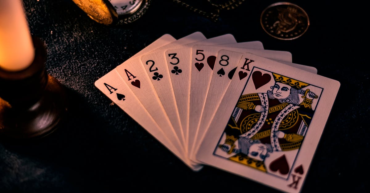 A dimly lit close-up of playing cards with a pocket watch, showcasing a nostalgic casino vibe.